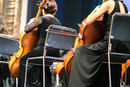 Cello in cellist hands at classical music symphony concert closeupの写真素材