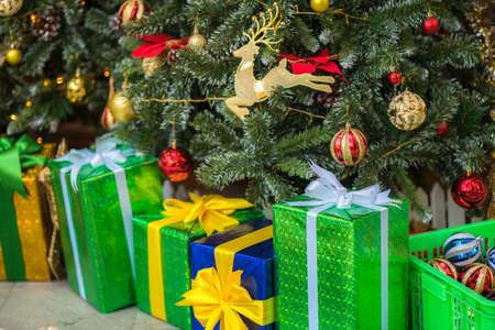 Christmas decorations on a christmas tree with gifts boxesの写真素材