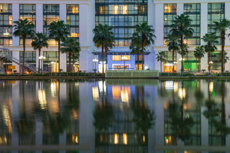 Illuminated building facades with reflection on lake.の写真素材