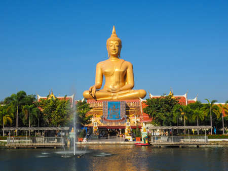BIG GOLDEN BUDDHA IN SINGBURI, THAILAND WITH FOUNTAINの写真素材