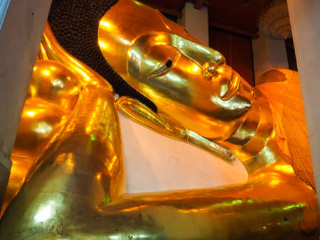 GOLDEN BUDDHA IN RESTING POSITIONの写真素材