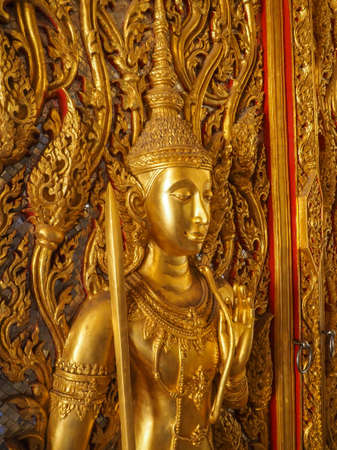 GOLDEN ANGLE CARVED ON THE GATE OF WAT THA SUNG THAILANDの写真素材