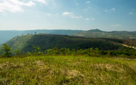 MOUNTAIN LANDSCAPE WITH ROAD ON THE HILLの写真素材