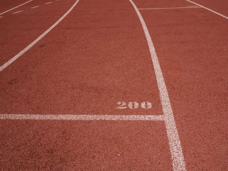 Red running track with white lines and 200 mark