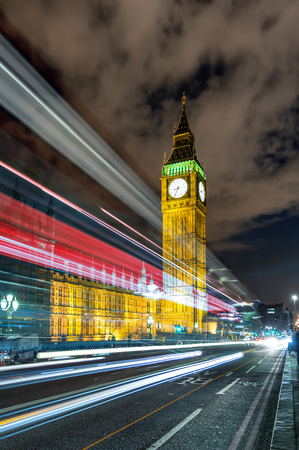 Passing by red bus in front of the Big Ben, Londonの写真素材