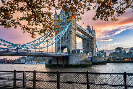 The Tower Bridge in London, United Kingdom, during an intense autumn sunsetの写真素材