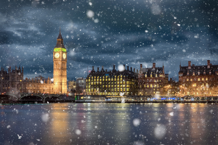 Big Ben and Westminster on a cold winter night with falling snow, London, United Kingdom