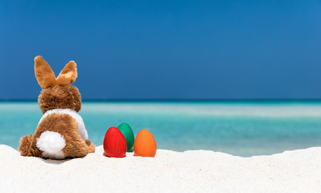 Bunny and colored easter eggs on a tropical beach in the Maldivesの写真素材