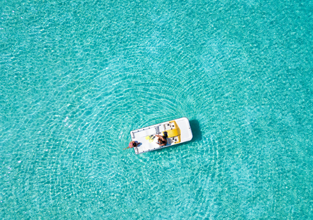 Couple is having fun with a pedalo boat on the turquoise waters of the Maldivesの写真素材