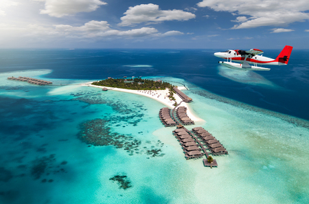 Aerial view of a tropical island in the Indian ocean with seaplane approaching, Maldivesの写真素材