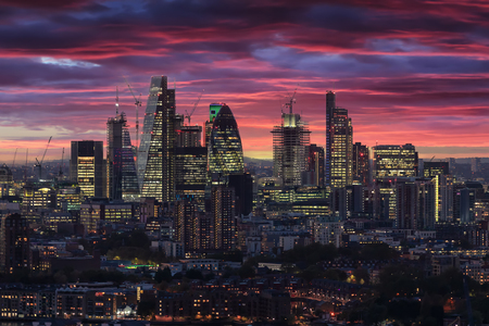 The illuminated City of London after sunset time, United Kingdomの写真素材