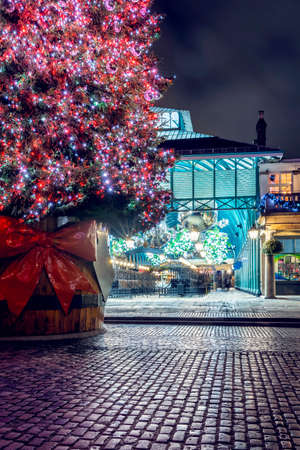 A illuminated Christmas tree for the festive winter season in the Covent Garden district, London, United Kingdomの写真素材
