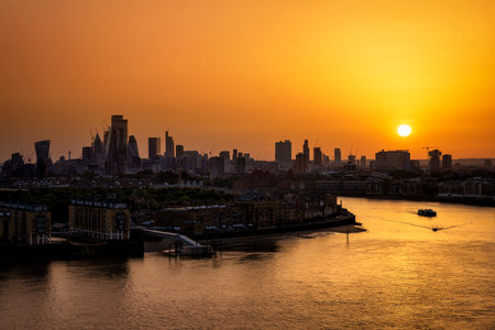 Panorama of the London skyline with river Thames during a fiery summer sunset, Englandの写真素材