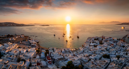 Elevated, panoramic summer sunset view of the town of Mykonos island with the famous windmills and Little Venice district, Cyclades, Greeceの写真素材