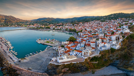 Panoramic aerial view of the town of Skopelos island with the traditional, red roofed houses during a calm summer sunset, Sporades, Greeceの写真素材