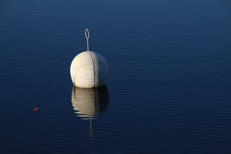 Buoy in calm waterの写真素材