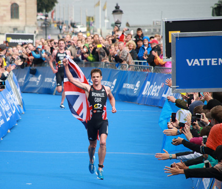 Alistar Brownlee on the finish of the Mens  triathlon ITU World Triathlon series event Aug 23, 2014 in Stockholm, Sweden. Only a few nmeters before his brotherのeditorial素材