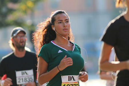 STOCKHOLM - SEPTEMBER 13, 2014: Young beautiful latin woman running in the Half marathon running...