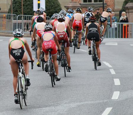 STOCKHOLM - AUG 23: Group of female cycling in the triathlon race in the Womenのeditorial素材
