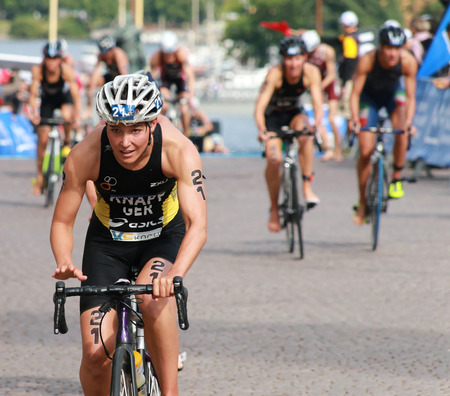 STOCKHOLM - AUG 23: Anja Knapp (GER) cycling after the swimming in the transition zone in the Womenのeditorial素材