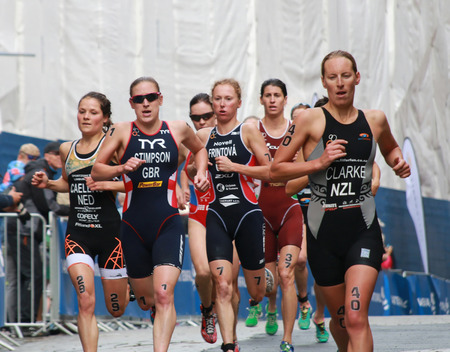 STOCKHOLM - AUG 23, 2014: Triathlete Jodie Stimpson(GBR), Rebecca Clark (NZL) and Vendula Frintova (CZE) and competitors running in the Women's ITU World Triathlon series event August 23, 2014 in Stockholm, Swedenのeditorial素材