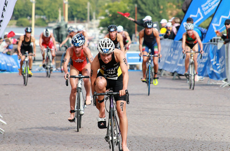 STOCKHOLM - AUG 23, 2014: Anja Knapp (GER) fixing the cycling shoe after the swimming in the transition zone in the Women's ITU World Triathlon series event August 23, 2014 in Stockholm, Swedenのeditorial素材