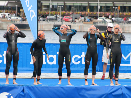 STOCKHOLM - AUG 23, 2014: Waiting for the start signal in the swimming part of theWomen's ITU World Triathlon series event Aug 23, 2014 in Stockholm, Swedenのeditorial素材