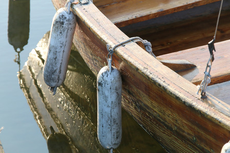 Reflections of row boat in calm water