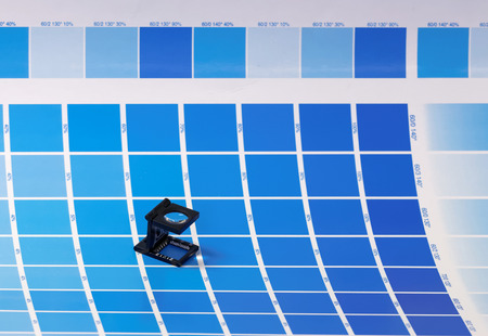 Loupe on a test print in many cyan shades - ready for inspection of the print qualityの写真素材