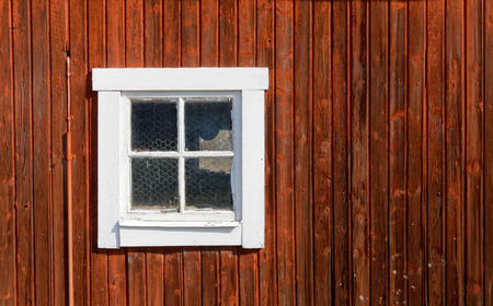 Red traditional barn wall and an old windowの写真素材