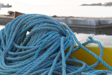 Pile of blue nylon rope in the harborの写真素材