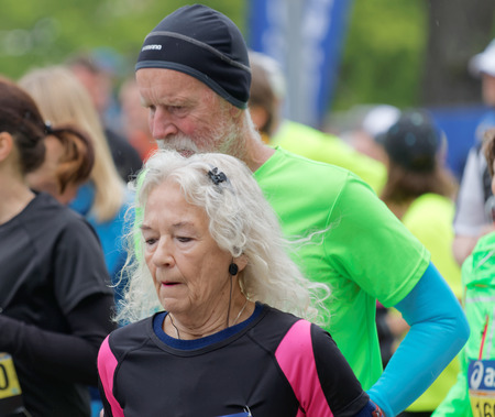 STOCKHOLM - MAY 30, 2015: Old woman and old man running in the ASICS Stockholm Marathon event May 30, 2015 in Stockholm, Swedenのeditorial素材