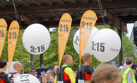STOCKHOLM - MAY 30, 2015: Officials with ballons and banners helping runners aiming for 3:15 hours to have the right speed in the ASICS Stockholm Marathon event May 30, 2015 in Stockholm, Swedenのeditorial素材