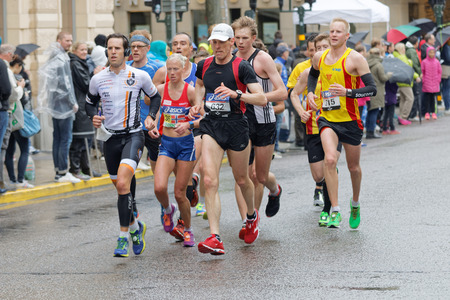 STOCKHOLM - MAY 30, 2015: Group of runner on wet asphalt after 15 km in the ASICS Stockholm Marathon event May 30, 2015 in Stockholm, Swedenのeditorial素材