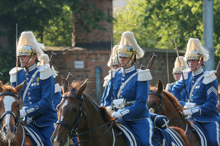 STOCKHOLM - JUN 06, 2015: The Royal guards on the horse back protecting the swedish royal family on their way to celebrate the swedish national dayのeditorial素材