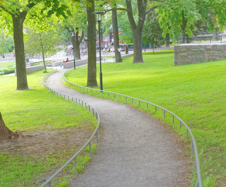 STOCKHOLM - JUN 13, 2015: Meander path in the public park Vasaparken with green trees, grass and...