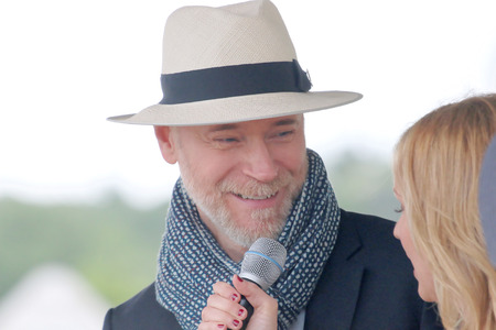 STOCKHOLM - JUNE 06, 2015: World famous clothes designer Lars Wallin interviewed as one of the judges at the hat parade at Nationaldags Galoppen at Gardet. June 6, 2015 in Stockholmのeditorial素材