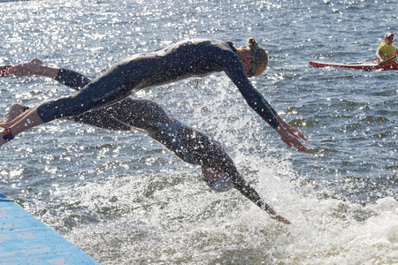 STOCKHOLM - AUG 22, 2015: Two female competitors jump into the water in the Women's ITU World Triathlon series event August 22, 2015 in Stockholm, Swedenのeditorial素材