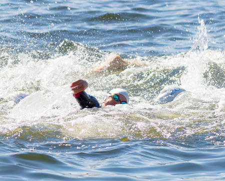 STOCKHOLM - AUG 22, 2015: Closeup of female crawler wearing swim glasses in the water in the Women's ITU World Triathlon series event August 22, 2015 in Stockholm, Swedenのeditorial素材