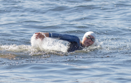 STOCKHOLM - AUG 22, 2015: Closeup of one female swimmer in the Women's ITU World Triathlon series event August 22, 2015 in Stockholm, Swedenのeditorial素材