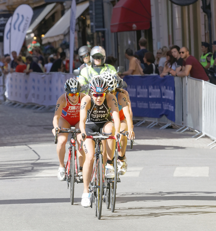 STOCKHOLM - AUG 22, 2015: Triathlete Yuko Takahashi  (JPN) cycling, followed by competitors in the Women's ITU World Triathlon series event August 22, 2015 in Stockholm, Swedenのeditorial素材