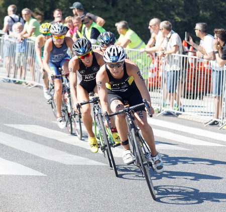 STOCKHOLM - AUG 22, 2015: Triathlete Anja Knapp (GER) cycling, followed by Andrea Hewitt and competitors in the Women's ITU World Triathlon series event August 22, 2015 in Stockholm, Swedenのeditorial素材