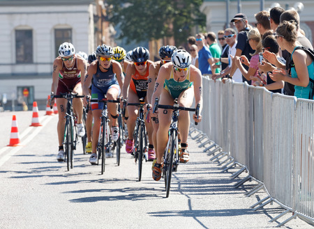 STOCKHOLM - AUG 22, 2015: Triathlete Gillian Backhouse (AUS) cycling, followed by competitors in the Women's ITU World Triathlon series event August 22, 2015 in Stockholm, Swedenのeditorial素材