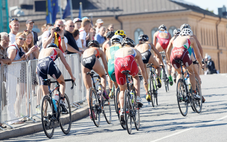 STOCKHOLM - AUG 22, 2015: Rear view of a large group of cyclists climbing a hill  in the Women's ITU World Triathlon series event August 22, 2015 in Stockholm, Swedenのeditorial素材