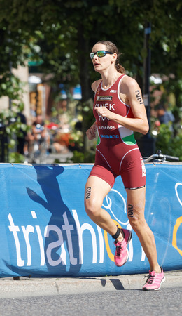STOCKHOLM - AUG 22, 2015: Triathlete Margit Vanek running in the Women's ITU World Triathlon series event August 22, 2015 in Stockholm, Swedenのeditorial素材