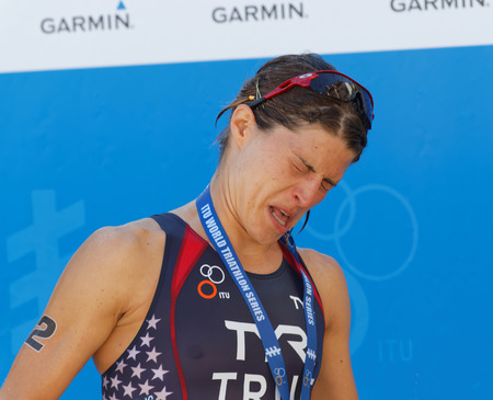 STOCKHOLM - AUG 22, 2015: Sarah True getting champagne in her eyes during the prize ceremny in the Women's ITU World Triathlon series event August 22, 2015 in Stockholm, Swedenのeditorial素材