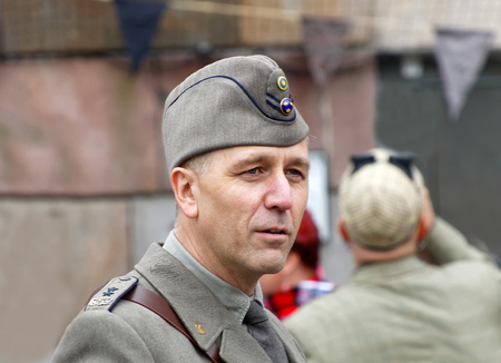 STOCKHOLM - SEPT 19, 2015: Man wearing gray old fashioned military clothes and bikes in the Bike in Tweed event September 19, 2015 in Stockholm, Swedenのeditorial素材