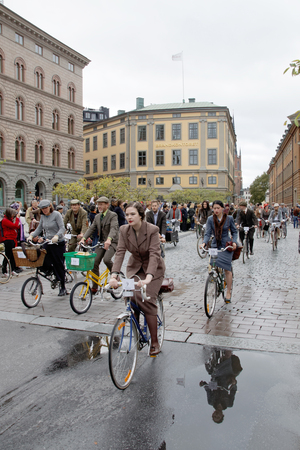 STOCKHOLM - SEPT 19, 2015: Group of elegant cycling people wearing old fashioned tweed clothes in the Bike in Tweed event September 19, 2015 in Stockholm, Swedenのeditorial素材
