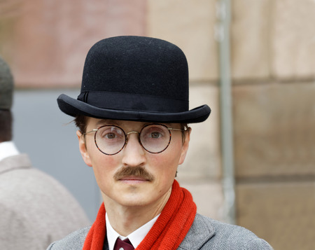 STOCKHOLM - SEPT 19, 2015: Young man with mustache wearing old fashioned tweed clothes, hat and glasses in the Bike in Tweed event September 19, 2015 in Stockholm, Swedenのeditorial素材
