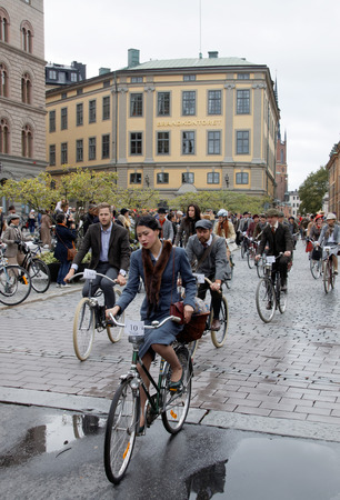 STOCKHOLM - SEPT 19, 2015: Group of elegant cycling people wearing old fashioned tweed clothes in the Bike in Tweed event September 19, 2015 in Stockholm, Swedenのeditorial素材